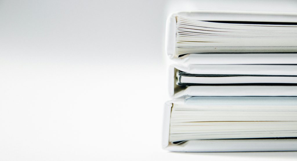 Stack of new laws and regulations contained in binders.