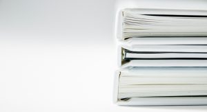 Stack of new laws and regulations contained in binders.